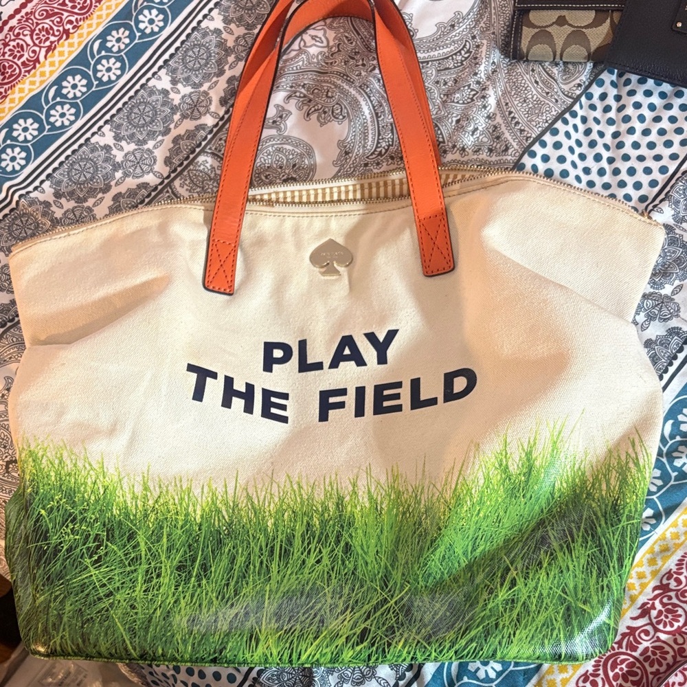 kate spade cream canvas tote with green grass print and orange handles